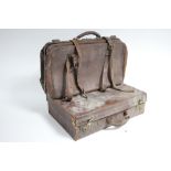 A tan leather suitcase fitted twin chrome lever locks, 22” wide; & a leather Gladstone type bag, 24”