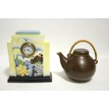 A 1930s Czechoslovakian ceramic cased mantel clock, 9¾" high; and a brown glazed globular teapot (