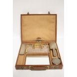 An Italian tan leather travelling grooming case with fitted interior including seven items with .925