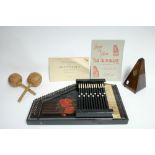 A Maelzel metronome in mahogany case, 8¾” high; together with an autoharp, boxed; a part set of