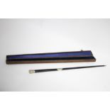 A late 19th/early 20th century black lacquered music conductor’s baton with white metal mounts, 20½”