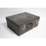 A late 19th/early 20th century tan leather travelling dressing case (lacking contents) with twin