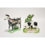 An early 19th century Staffordshire pottery model of a dog on the scent, with bocage support &