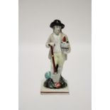 An early 19th century Staffordshire pearlware standing male figure of a gardener holding a potted