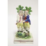 An early 19th century Staffordshire pearlware bocage group titled: “Friendship”, with two standing