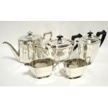 A Four-piece tea service of plain oblong design; & a late Victorian engraved oval tapered teapot.