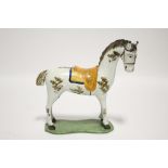 A late 18th/early 19th century Pratt-ware standing model of a horse on shaped flat base; 7" high x