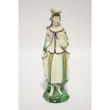 A late 18th century Whieldon creamware standing figure of a shepherdess, decorated in manganese,