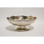 A George V circular shallow bowl with shaped rim, panelled sides, & on short pedestal foot, 7¼”