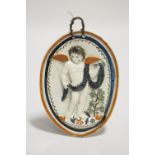A late 18th/early 19th century Pratt-ware oval plaque moulded in relief with a standing cherub