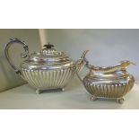 A late Victorian silver teapot of oval,