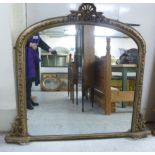 A late 19thC overmantel mirror, the arch