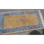 A Chinese washed woollen rug with flora