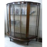 A 1950s walnut bow front display cabinet