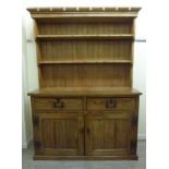 An early 20thC waxed pitch pine dresser,