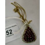 A teardrop pendant, set with rubies, sur