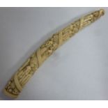 An early 20thC short ivory tusk, carved