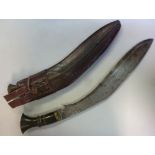 An early 20thC kukri, having a brass mou