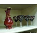 A set of six decoratively cut glass wine