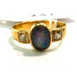 An 18ct gold ring with an opal set betwe