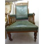 An early 20thC oak framed open arm chair