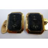 A pair of gold coloured metal tablet and