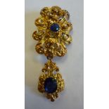 A gold coloured metal pendant brooch, se