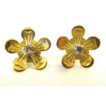 A pair of gold coloured metal flowerhead