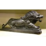 A carved model, a snarling lion, on a ch