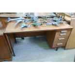 A 1970s teak desk, having a single pedes