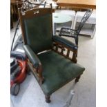 An early 20thC oak framed open arm chair