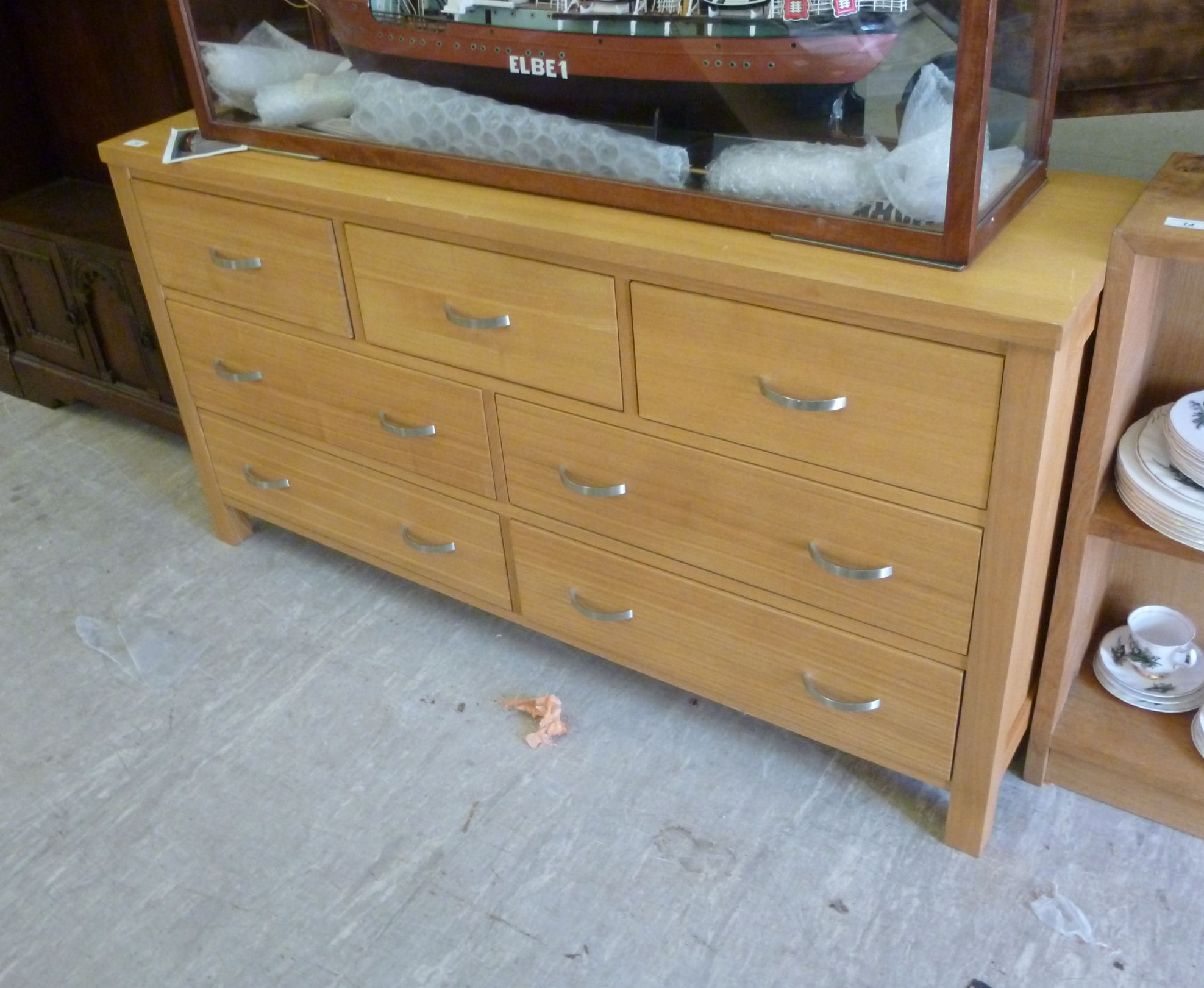 A modern pale oak seven drawer dressing