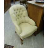 A mid 20thC nursing chair, upholstered i