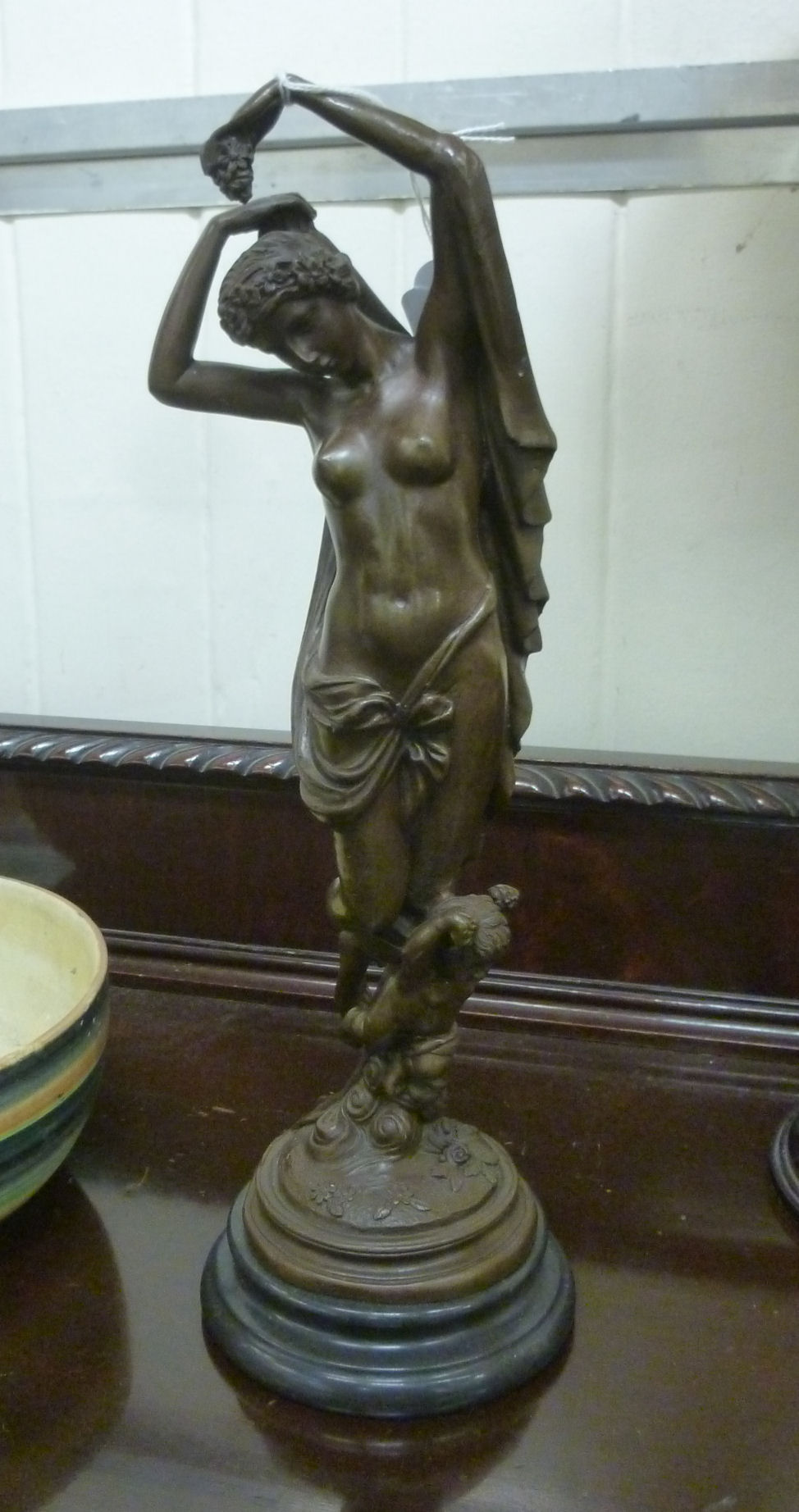 A cast and patinated bronze figure, a cl