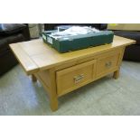 A modern pale oak coffee table with a pa