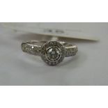 An 18ct gold and diamond set halo ring