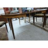 A modern oak finished dining table, rais