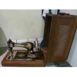 A Singer manual sewing machine, under a