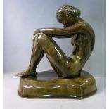 A mid 20thC porcelain figure, a seated n