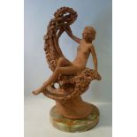 An early 20thC terracotta figure, a seat