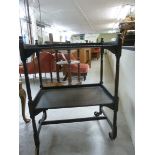 A 1930s oak two tier tea trolley with tu