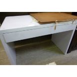 A modern white laminate finished desk, t