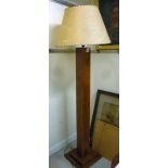 A mid 20thC mahogany standard lamp, the