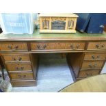 A modern oak finished desk, having a too