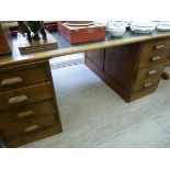 A 1920s oak partners' desk of panelled d