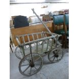 An early 20thC artisan's pine handcart,