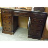 An early 20thC stained mahogany desk, ha