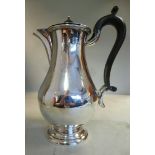 A silver pear shaped hot water pot with