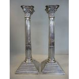 A pair of silver candlesticks, each havi