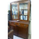 A 1930s mahogany display cabinet, having